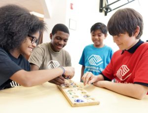 Group of Kids at Table Playing Game