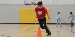 Boy Running Cones in Gym